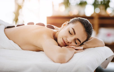woman getting a hot stone massage